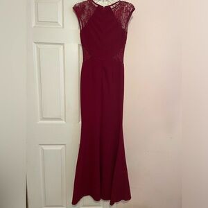 Size Small maroon formal dress. Lace sleeves, side cut-outs. Promgirl brand